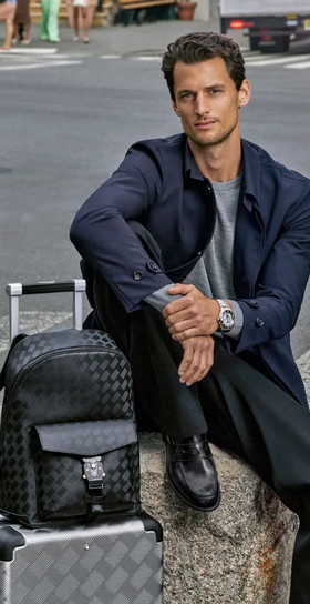 A man wearing a Montblanc suit in navy blue with a grey shirt
