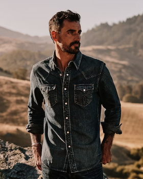 A man wearing a denim Huckberry western button up shirt