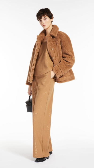 A woman wearing an all brown Max Brown outfit with a fleece overcoat