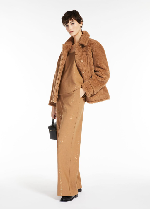 A woman wearing an all brown Max Brown outfit with a fleece overcoat