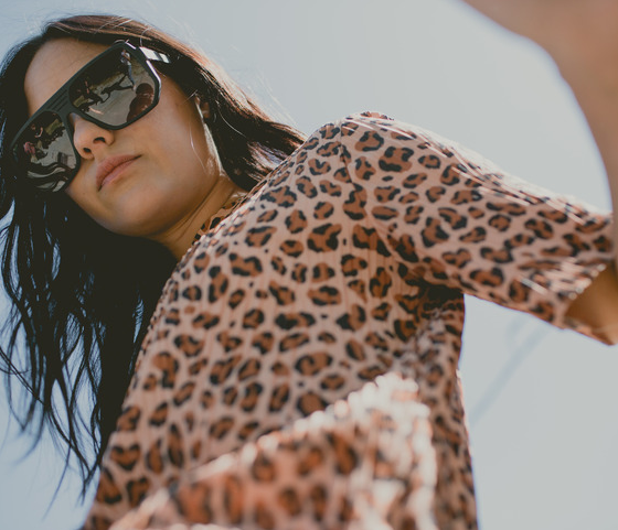 A woman wearing a pair of oversize Vonzipper sunglasses