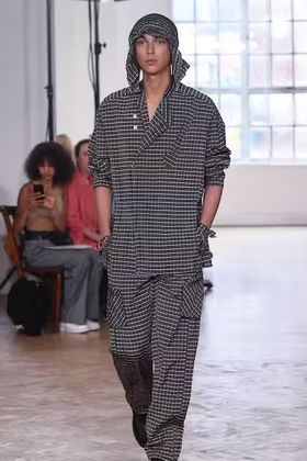 A woman wearing a Yeezy dark grey outfit