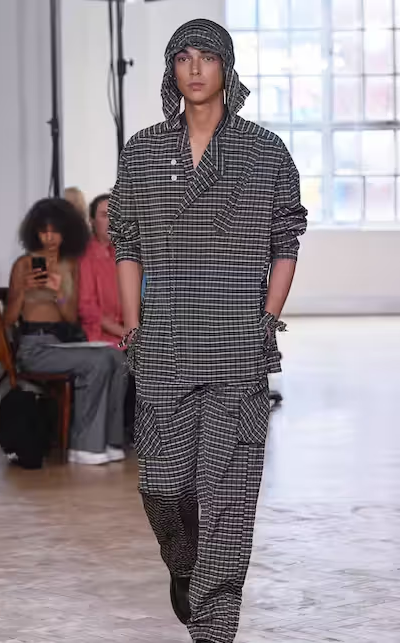 A woman wearing a Yeezy dark grey outfit
