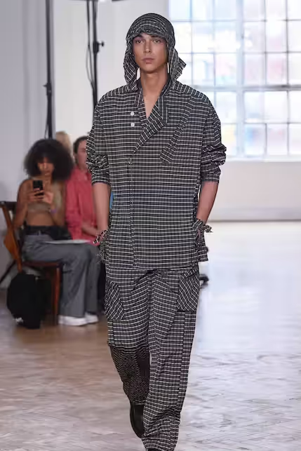 A woman wearing a Yeezy dark grey outfit