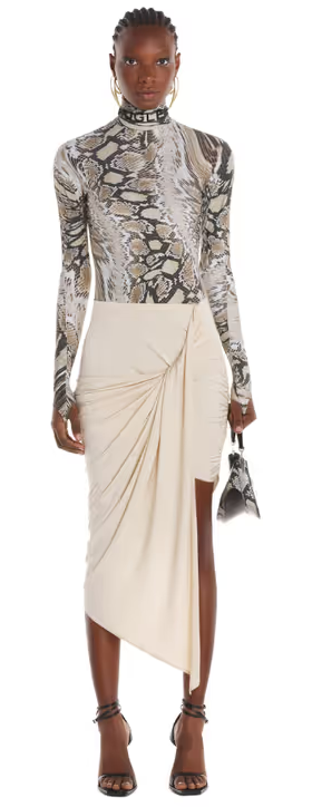 A woman wearing a crocadile print tight fitting Mugler shirt with a skirt