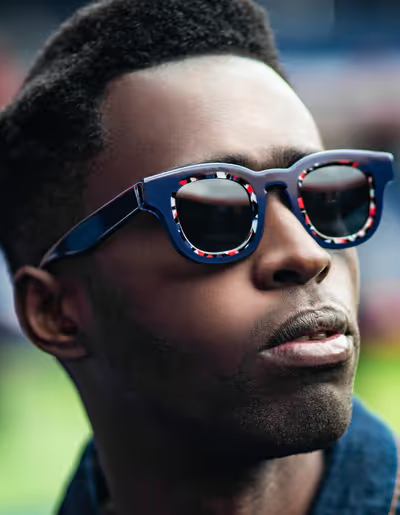 A man wearing a Thierry Lasry pair of colorful glasses