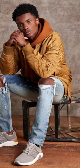 A man wearing a grey Skechers with white soles