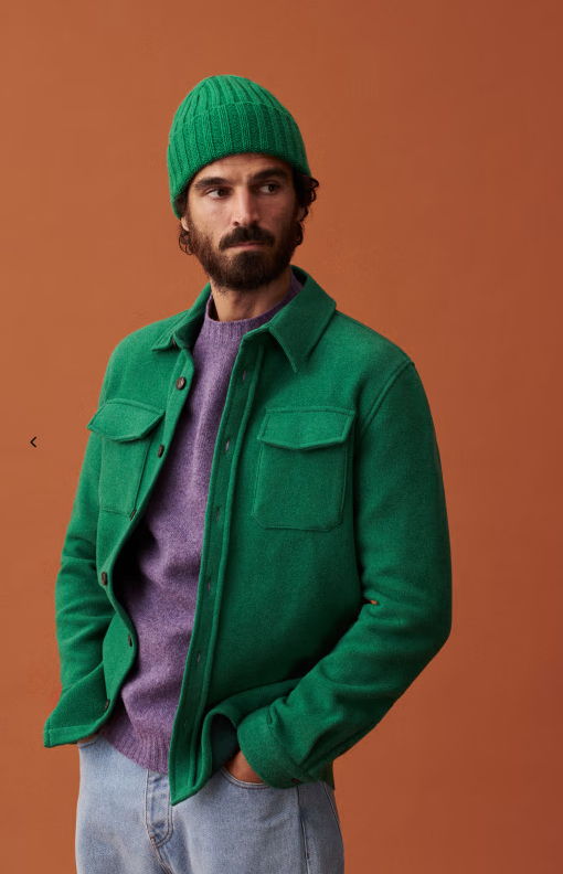 A man wearing a green Sezane jacket with matching beanie