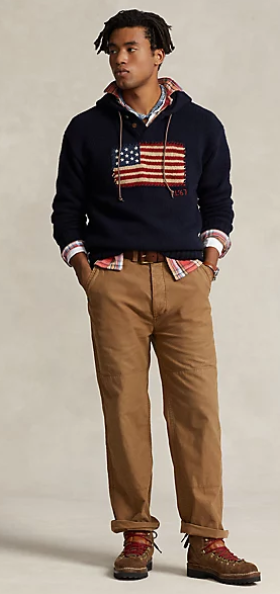 A man wearing a RRL USA flag hoodie with brown chinos