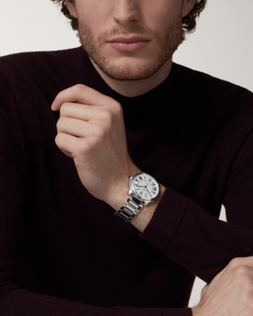 A man wearing a Cartier watch in silver