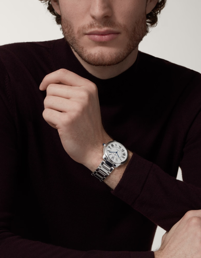 A man wearing a Cartier watch in silver