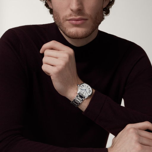 A man wearing a Cartier watch in silver