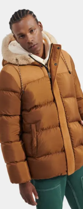 A man wearing a brown puffy jacket