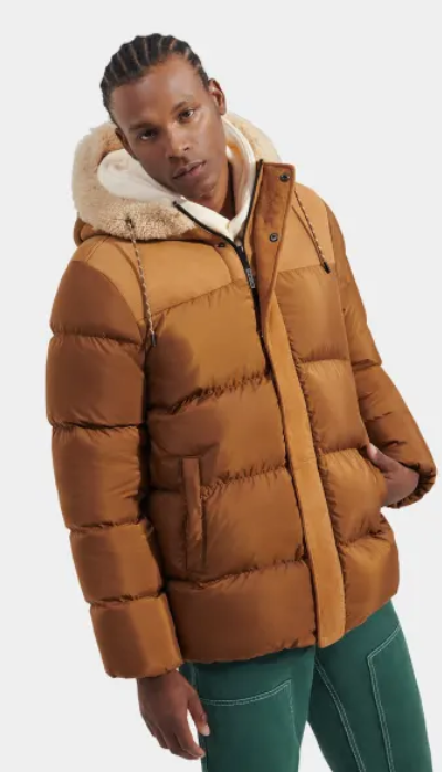 A man wearing a brown puffy jacket