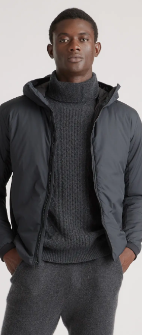 A man wearing a QUINCE turtle neck and jacket in dark grey