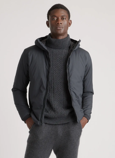 A man wearing a QUINCE turtle neck and jacket in dark grey