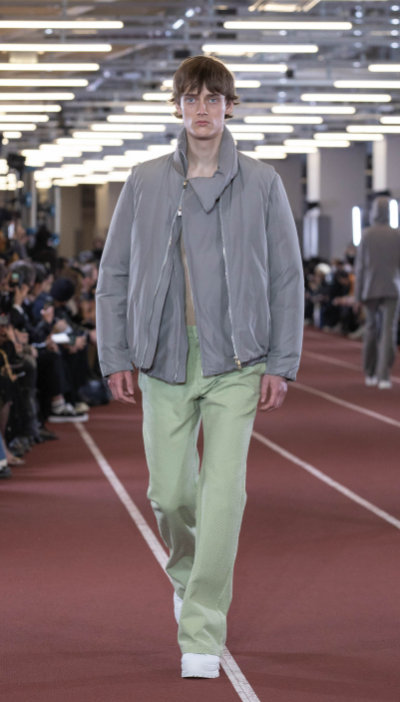 A man wearing an Attachment outfit in grey and pistachio green pants