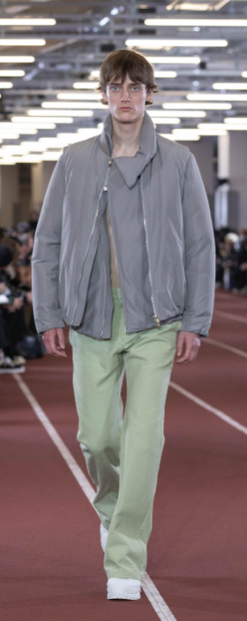A man wearing an Attachment outfit in grey and pistachio green pants