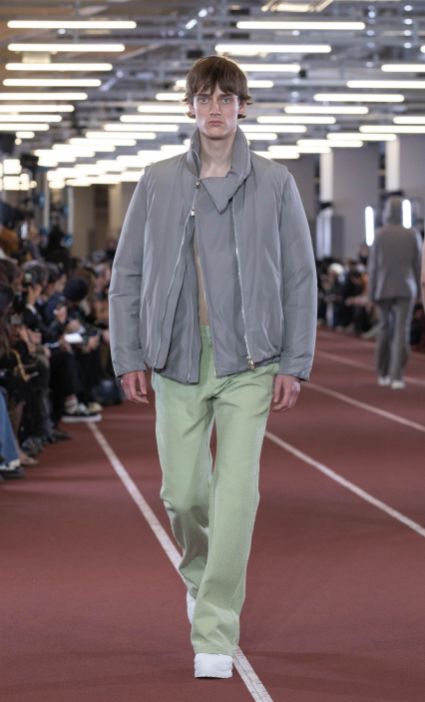 A man wearing an Attachment outfit in grey and pistachio green pants