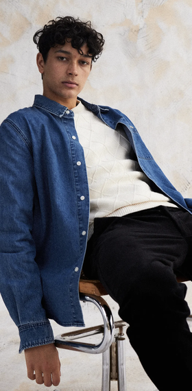 A man wearing an oversize I Love Ugly t-shirt