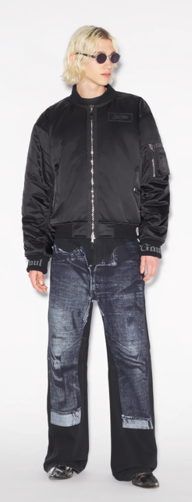 A man wearing a Jean Paul Gaultier black jacket and dark denim