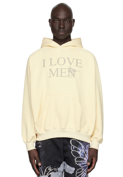 A man wearing a 'I Love Men' Praying hoodie and colorful butterfly pants