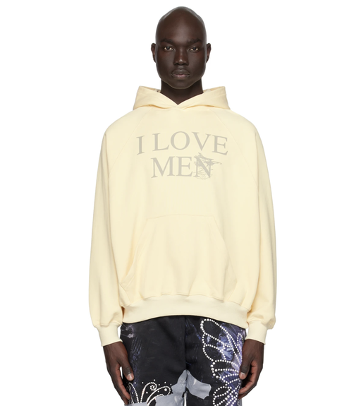 A man wearing a 'I Love Men' Praying hoodie and colorful butterfly pants