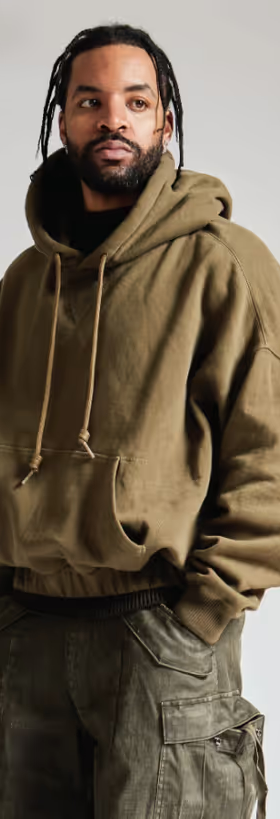 A man wearing a R13 hoodie and army green pants