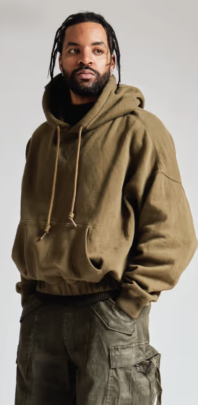 A man wearing a R13 hoodie and army green pants