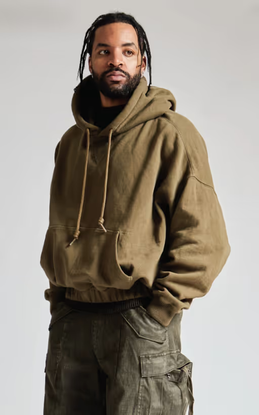A man wearing a R13 hoodie and army green pants