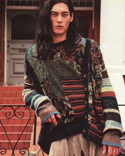 A man wearing a colorful Vivenne Westwood sweater