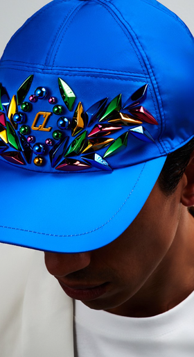 A man wearing a blue colorful Christian Louboutin
