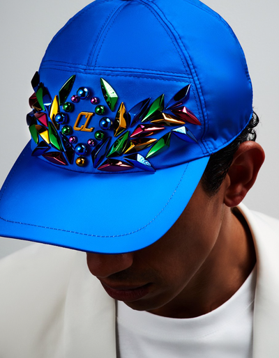 A man wearing a blue colorful Christian Louboutin