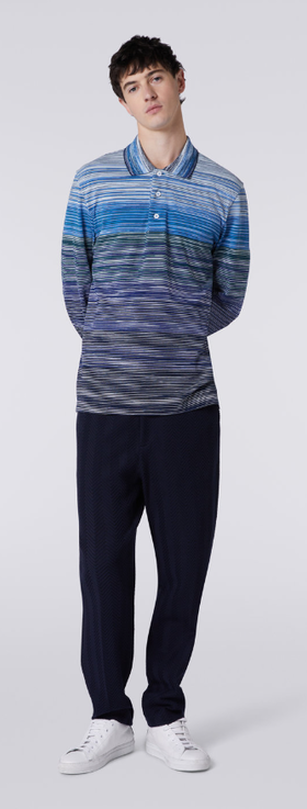 A man wearing a blue Missoni colored long-sleeve and black pants