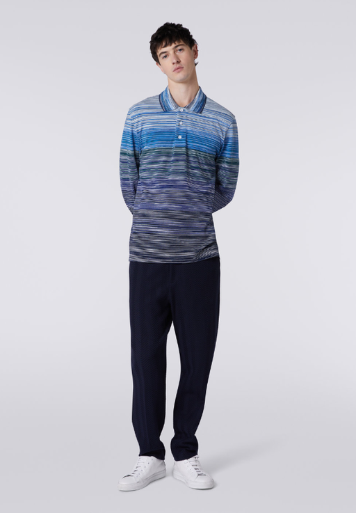 A man wearing a blue Missoni colored long-sleeve and black pants