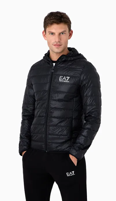 A man wearing an emporio armani light green leath jacket with black pants