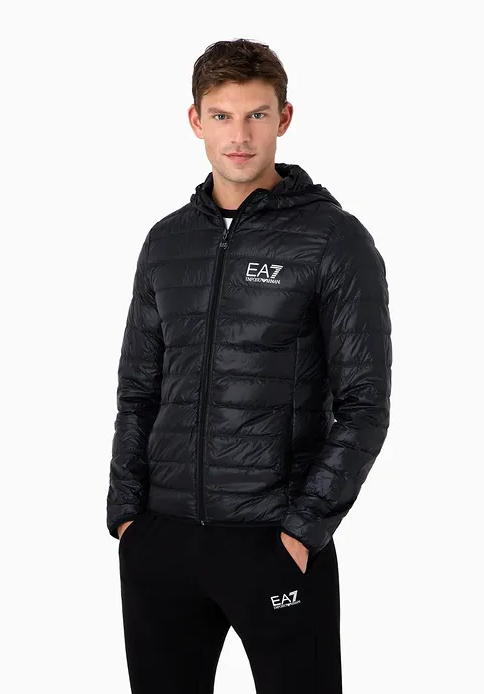 A man wearing an emporio armani light green leath jacket with black pants