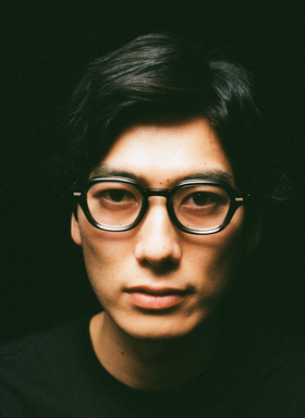 A man wearing a pair of Yuichi Toyama black eyeglasses
