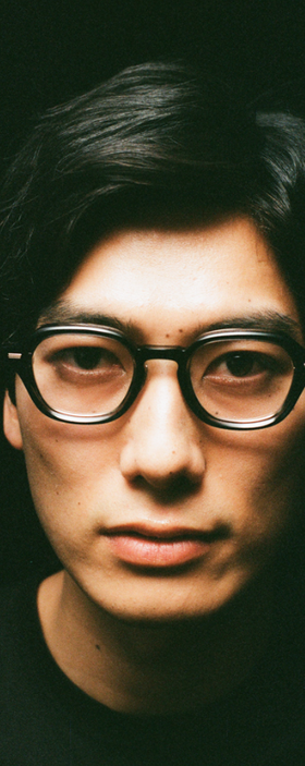 A man wearing a pair of Yuichi Toyama black eyeglasses