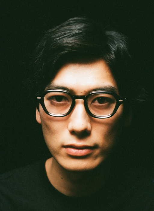 A man wearing a pair of Yuichi Toyama black eyeglasses