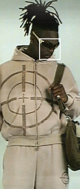 A man wearing a bullseye light brown Named Collective hoodie
