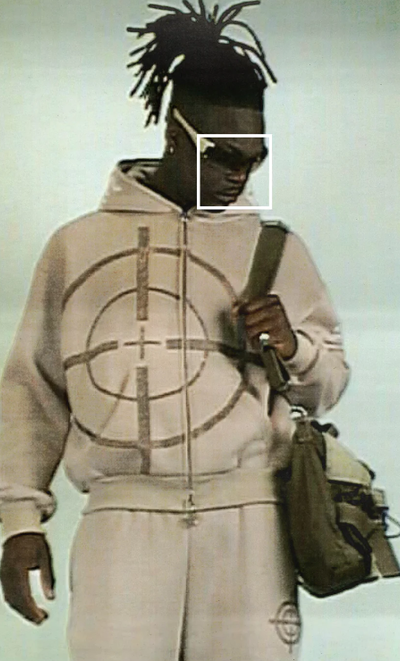 A man wearing a bullseye light brown Named Collective hoodie