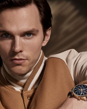 A man wearing a Jaeger-LeCoultre watch and a brown jacket