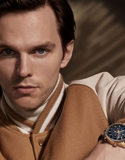 A man wearing a Jaeger-LeCoultre watch and a brown jacket