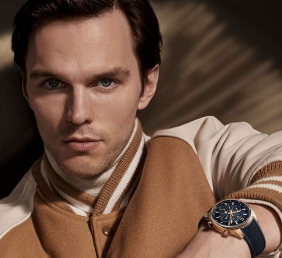 A man wearing a Jaeger-LeCoultre watch and a brown jacket