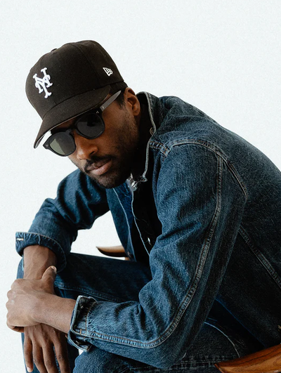 A man wearing a 3sixteen jacket and a black hat