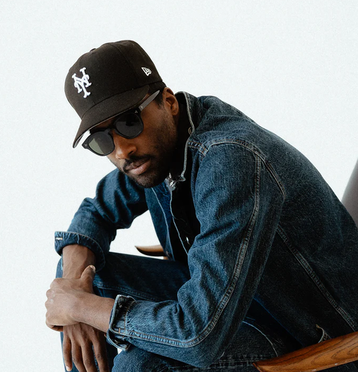 A man wearing a 3sixteen jacket and a black hat