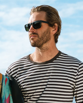 A man wearing a pair of black Electric Sunglasses