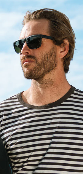 A man wearing a pair of black Electric Sunglasses