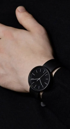 A man wearing a black Uniform Wares watch